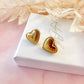 Gold puff heart stud earrings.