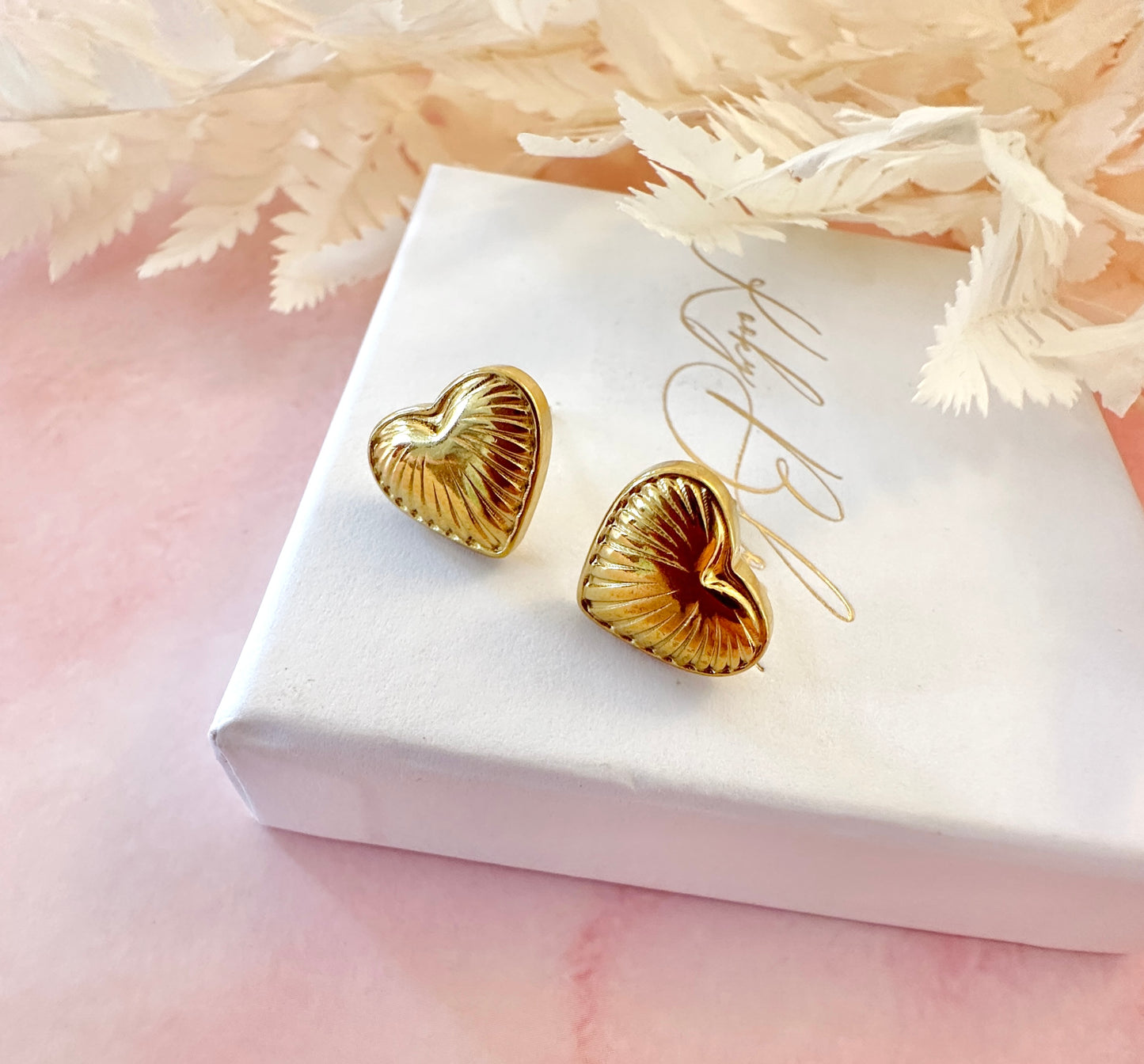 Gold puff heart stud earrings.