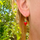 Tiny enamel Strawberry gold huggie earrings.