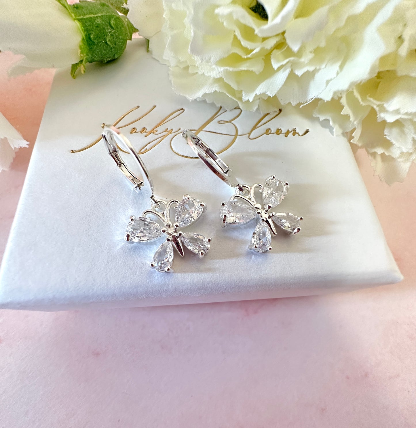 Butterfly CZ Silver huggie hoop earrings.