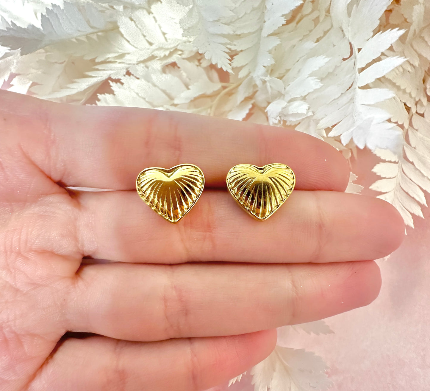 Gold puff heart stud earrings.