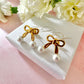 Gold Pearl Bow stud earrings.