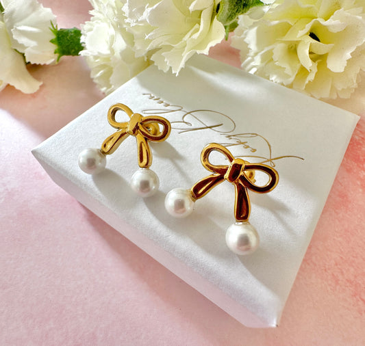 Gold Pearl Bow stud earrings.