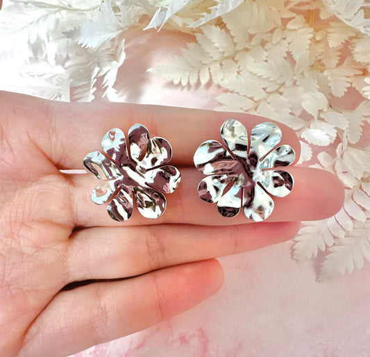 Silver oversized hammered flower stud earrings.