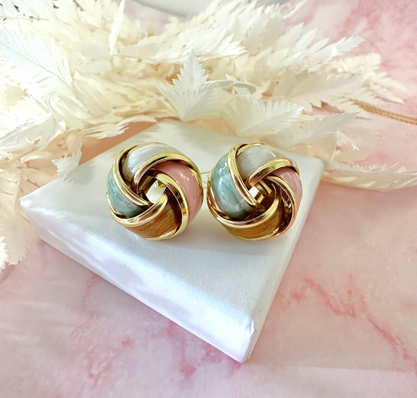 Gold Enamel Knot oversized stud earrings.