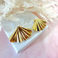 Gold Fan oversized stud earrings.