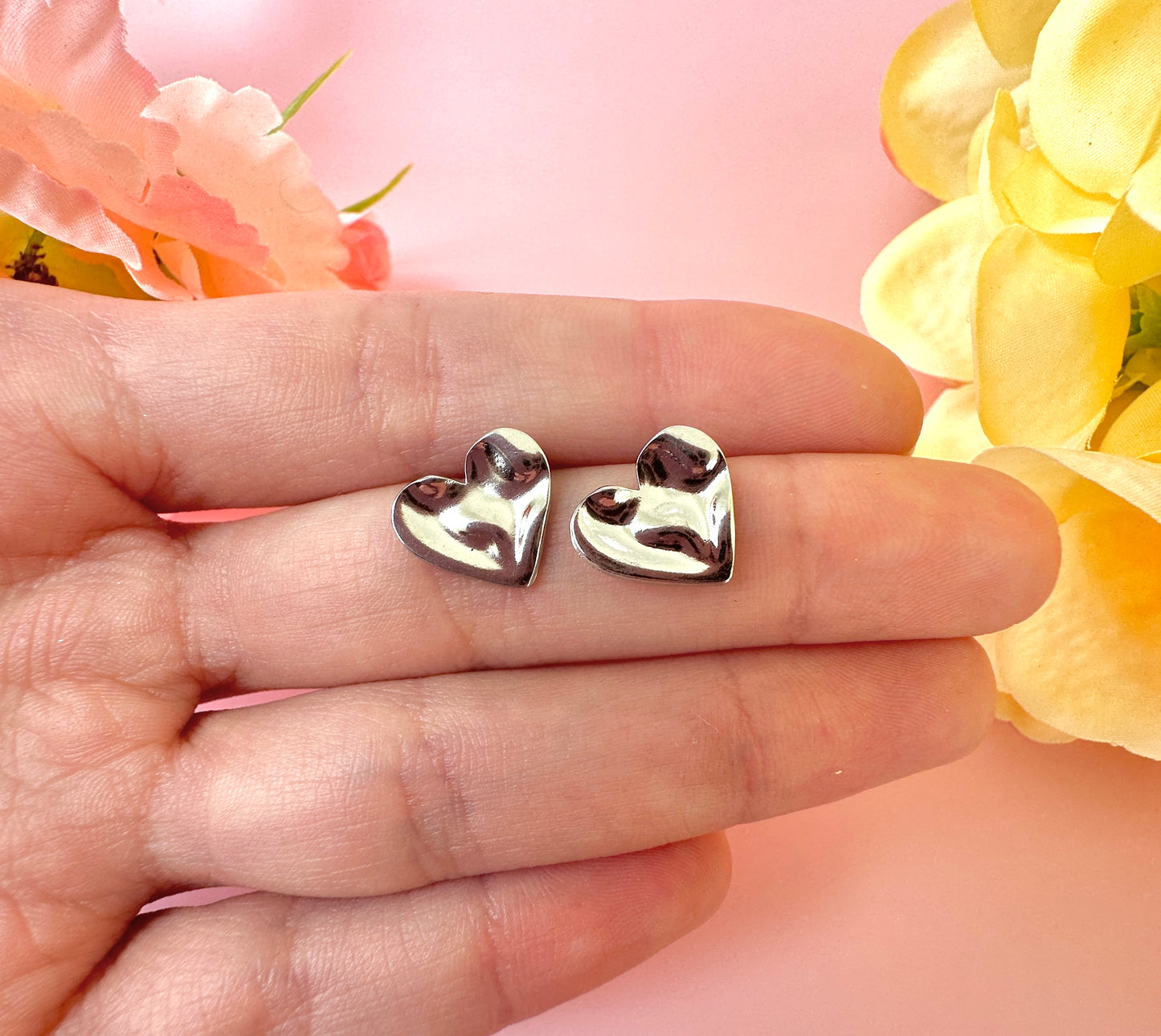 Silver Wobbly Heart stud earrings.