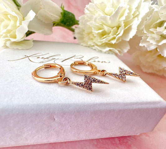 Gold CZ Lightning Bolt Huggie hoop earrings.