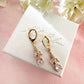 Gold CZ Flower drop Huggie earrings.