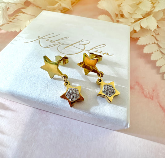 Gold double star diamanté dangle stud earrings.