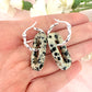 Silver Dalmatian Jasper gemstone twist hoop earrings.