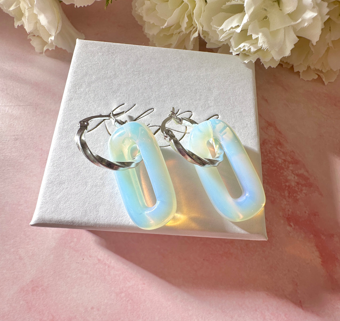 Silver Opalite gemstone twist hoop earrings.