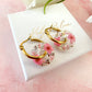 Pink blossom bloom flower donut earrings.