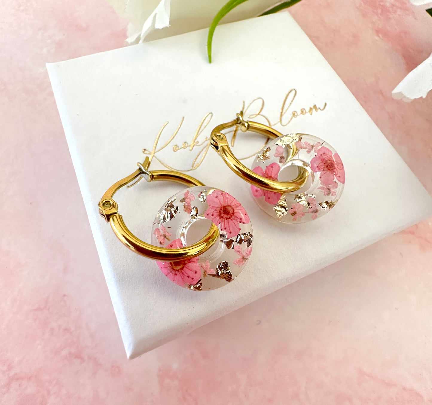 Pink blossom bloom flower donut earrings.