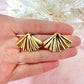 Gold Fan oversized stud earrings.