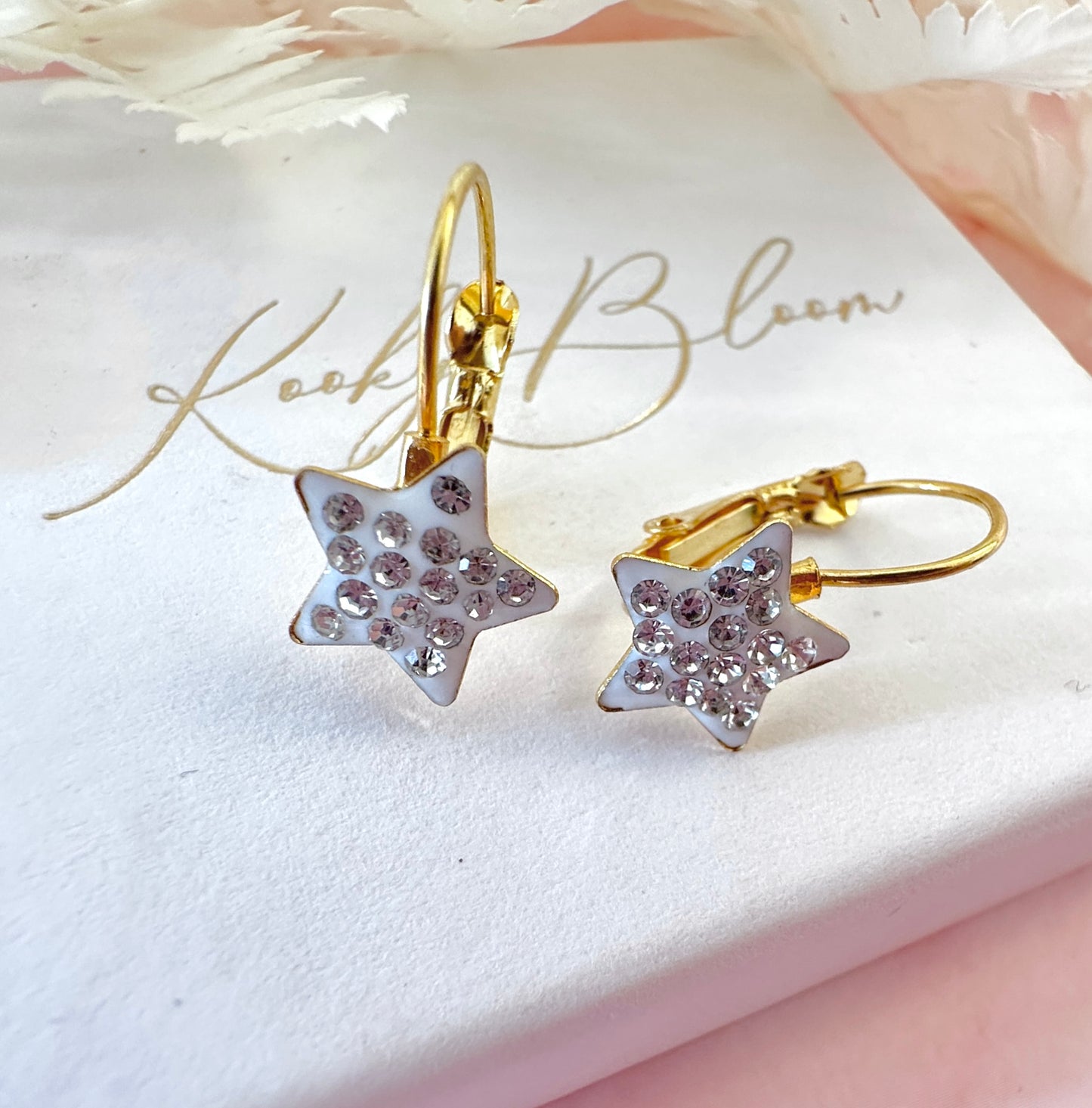 Gold White Diamanté Star leverback earrings.