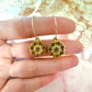 Gold sunflower hoop earrings.