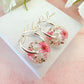 Pink blossom bloom flower donut earrings.