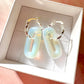 Silver Opalite gemstone twist hoop earrings.