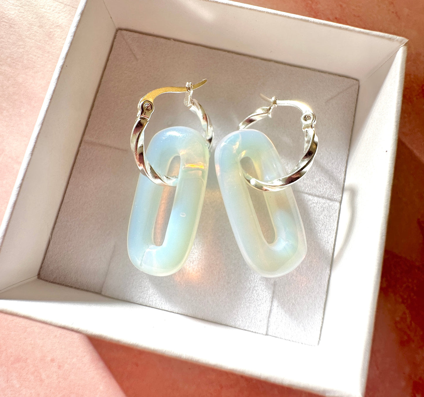 Silver Opalite gemstone twist hoop earrings.