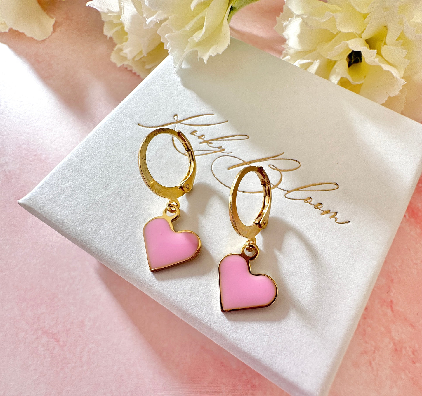 Gold Enamel Heart Huggie earrings.