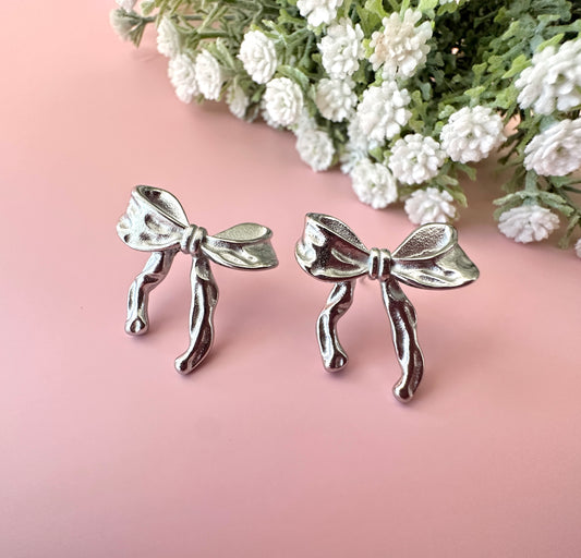 Silver Bow stud earrings.