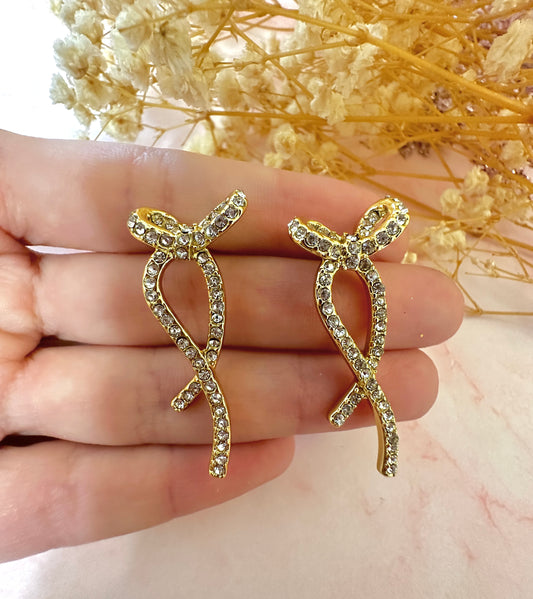 Gold long diamanté Bow stud earrings.