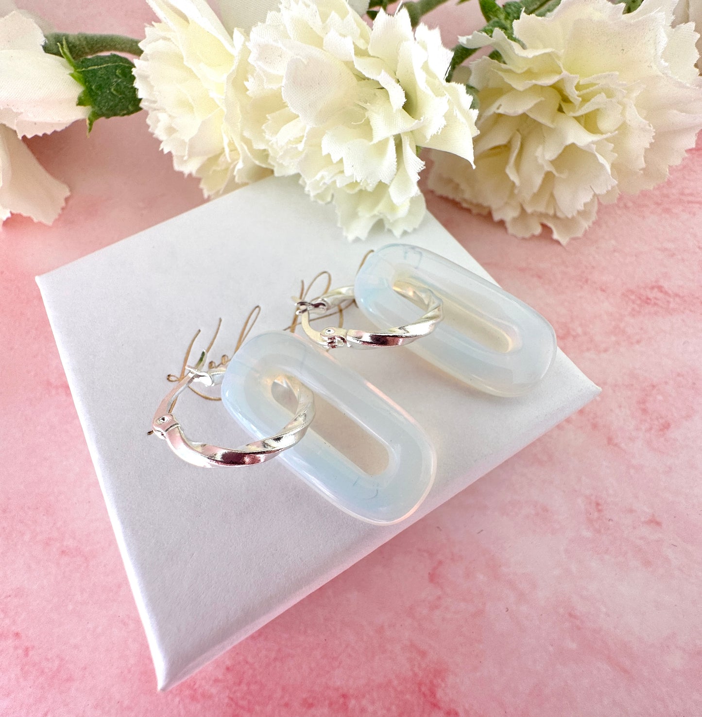 Silver Opalite gemstone twist hoop earrings.