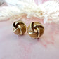 Gold Enamel Knot oversized stud earrings.