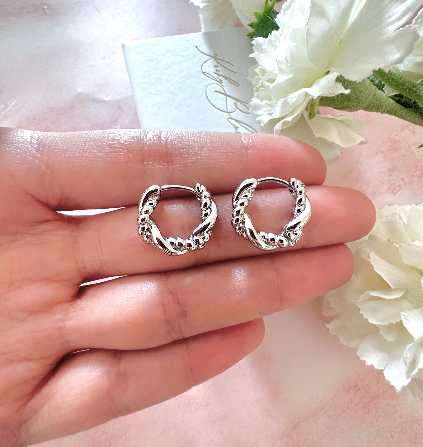 Silver twist Rope Huggie earrings.