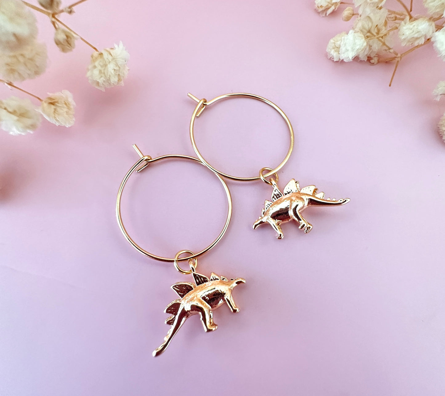 Gold dinosaur hoop earrings.