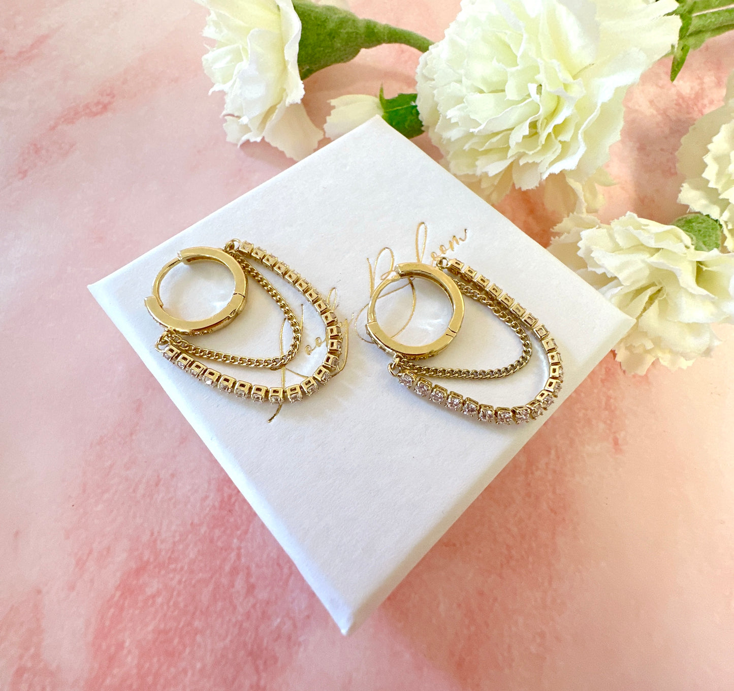 Gold CZ chain Huggie hoop earrings.