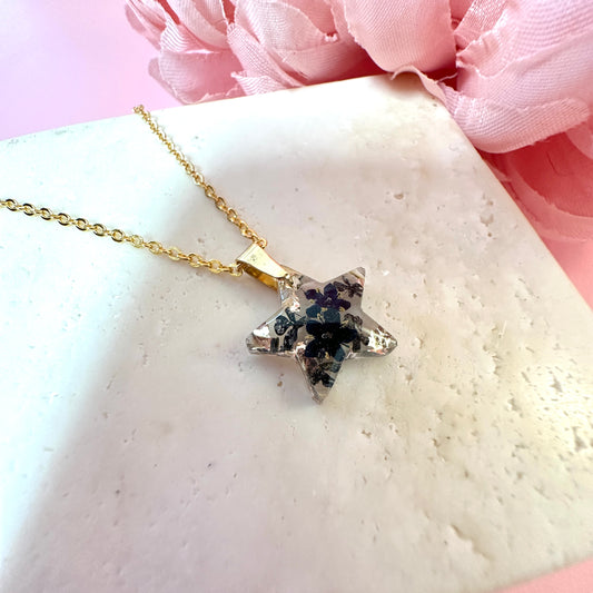 Gold Tiny black flower star necklace.