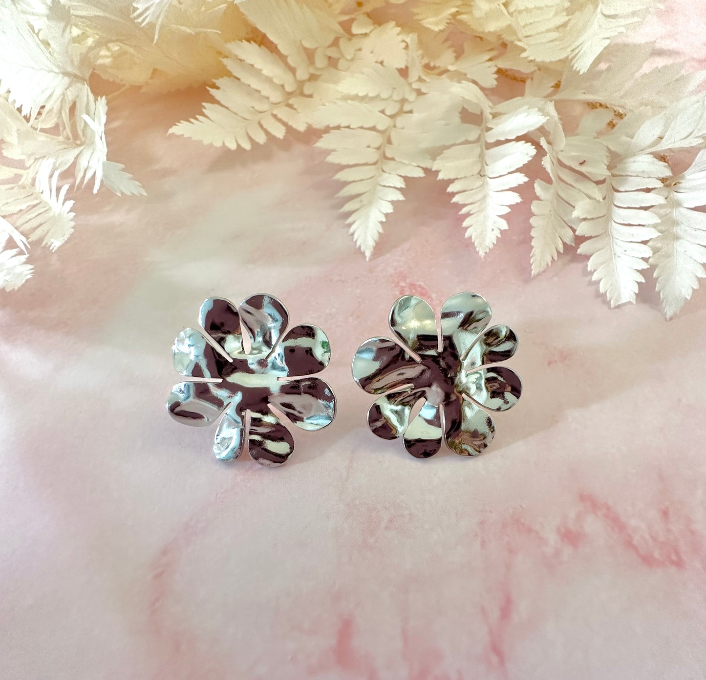 Silver oversized hammered flower stud earrings.