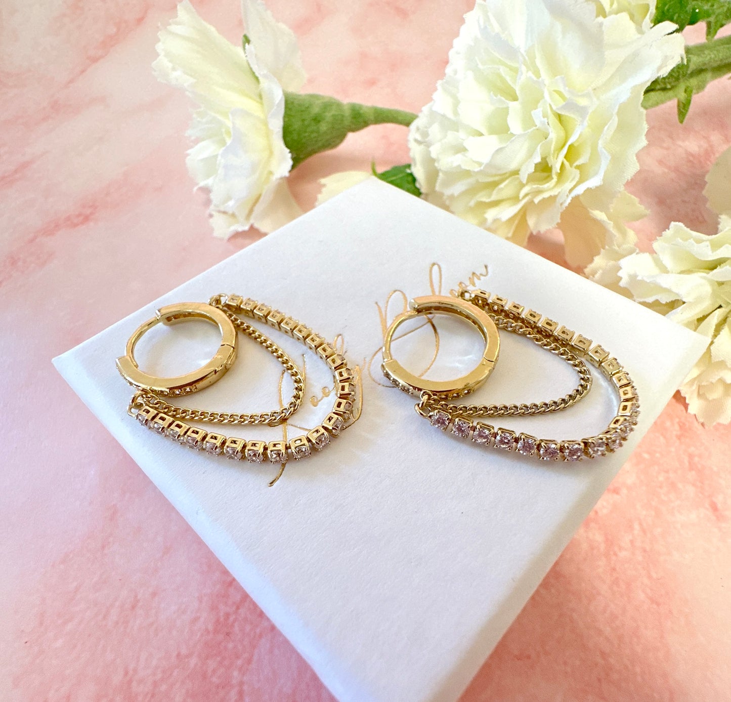 Gold CZ chain Huggie hoop earrings.