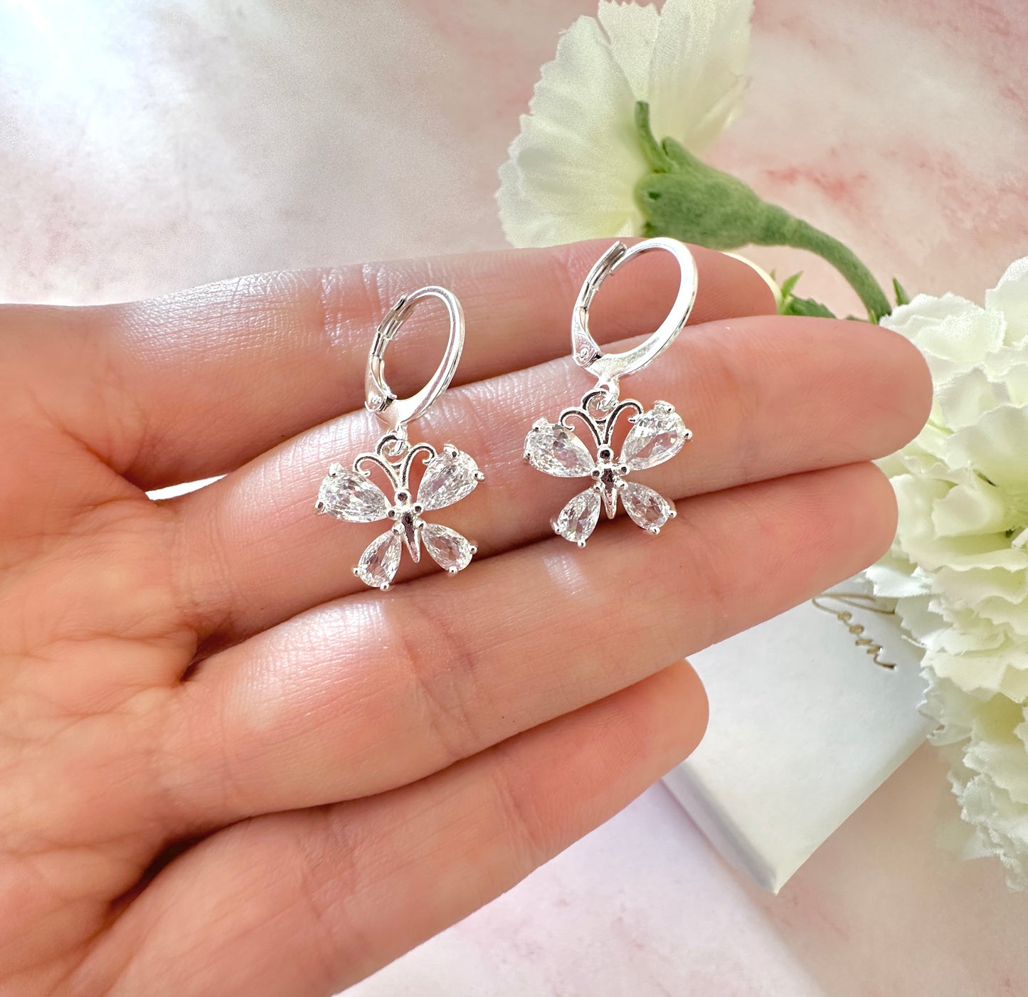 Butterfly CZ Silver huggie hoop earrings.