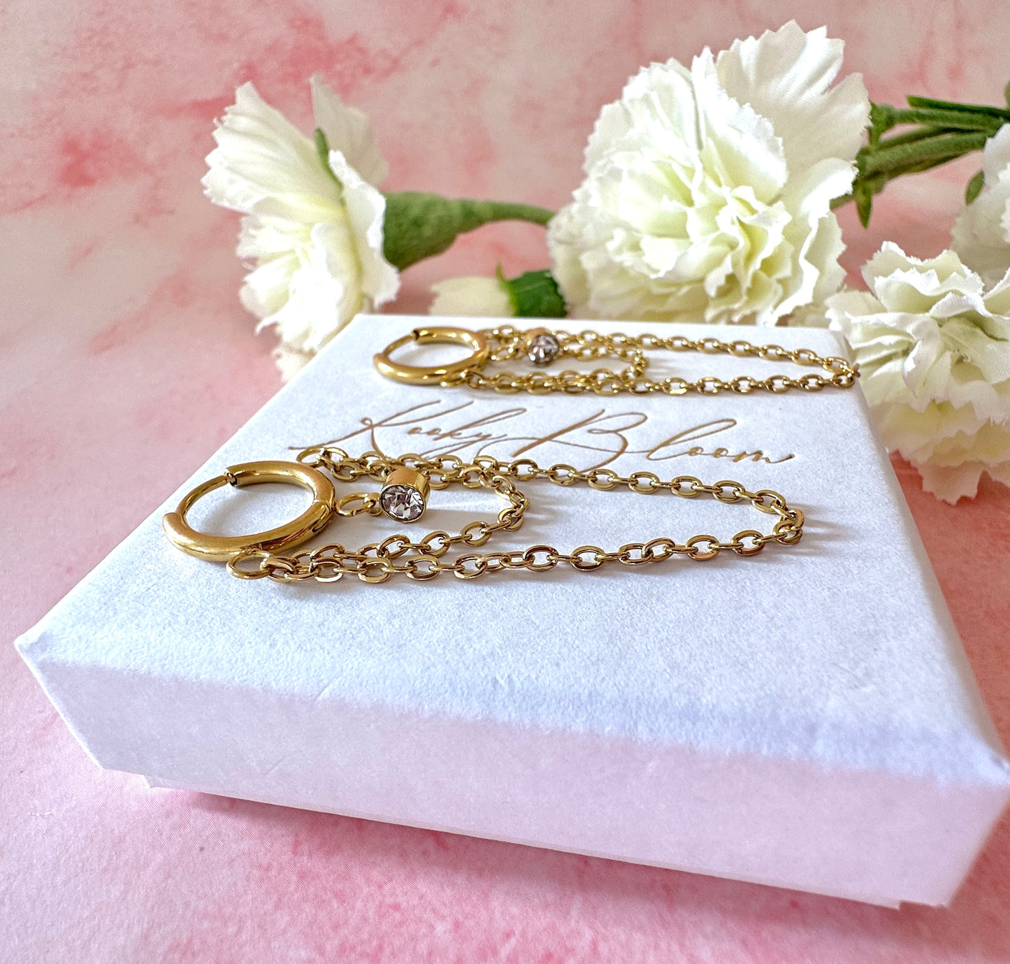 Gold Double chain drape Huggie earrings.