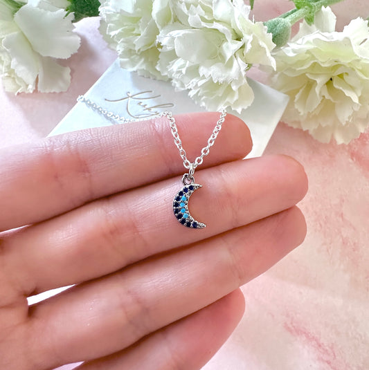 Silver tiny blue stone Moon necklace.