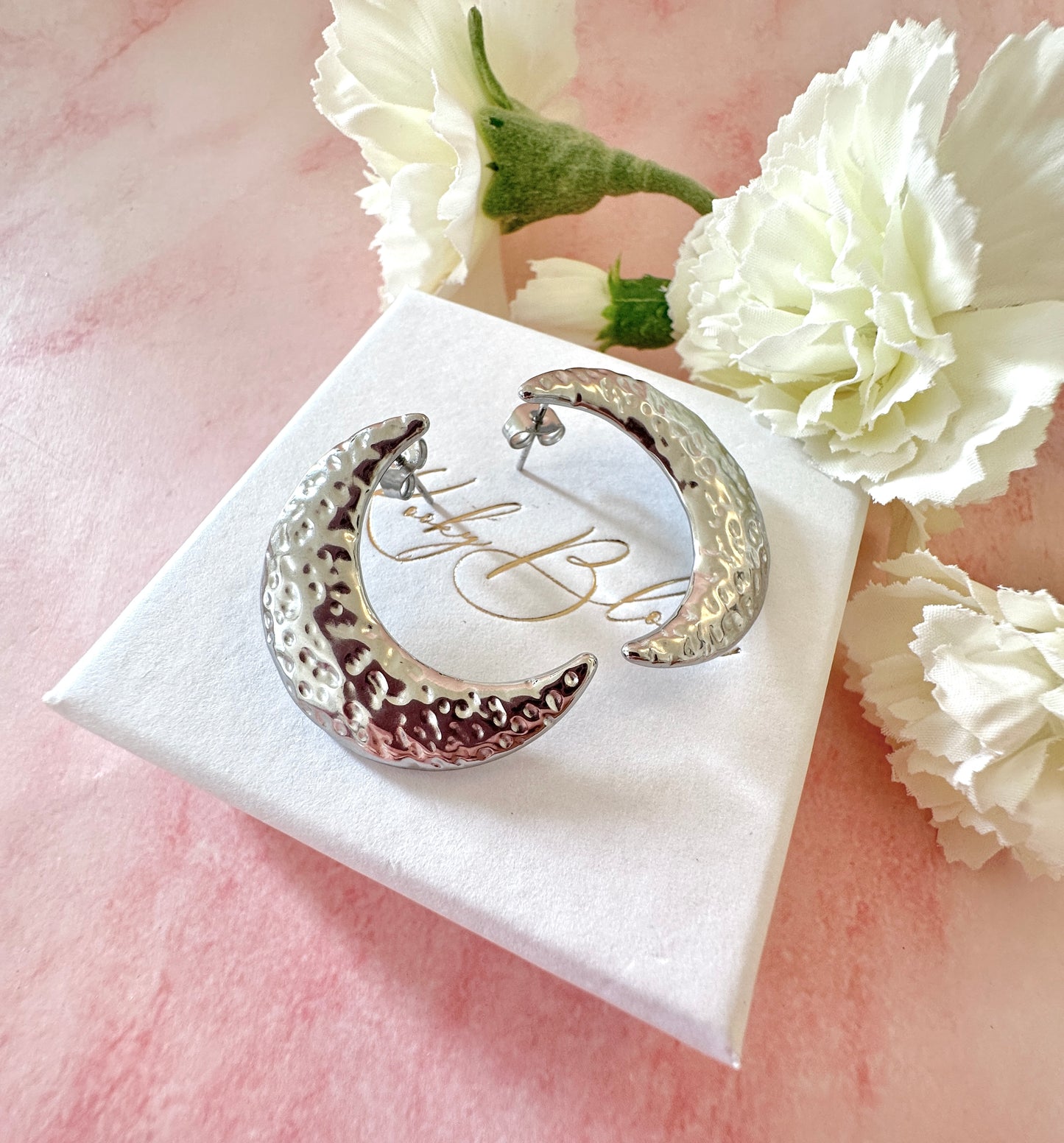 Silver oversized moon crescent stud earrings.